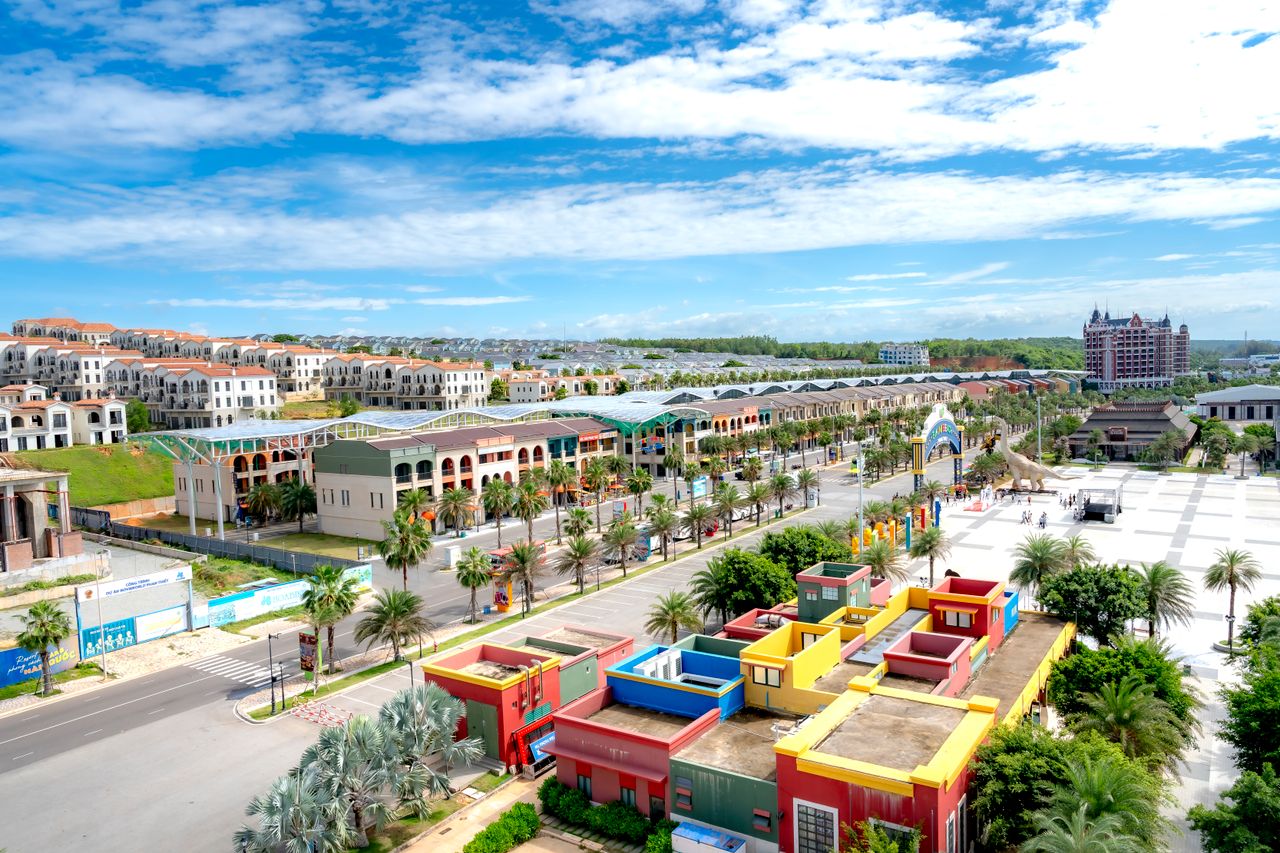 A vibrant cityscape featuring colorful buildings and modern design under a bright sky.