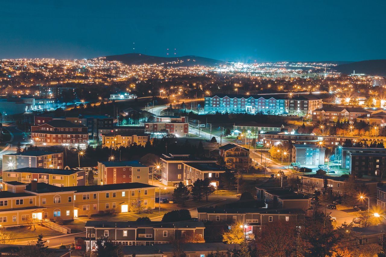 About Aerial view of a city at night showcasing vibrant lights and scenic urban architecture.
